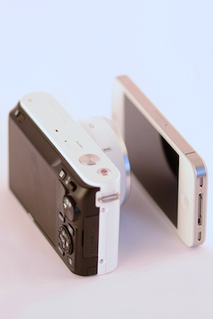 http:  taishimizu.com pictures nikon j1 review nikon j1 and white iPhone 4s angled 2 thumb.jpg